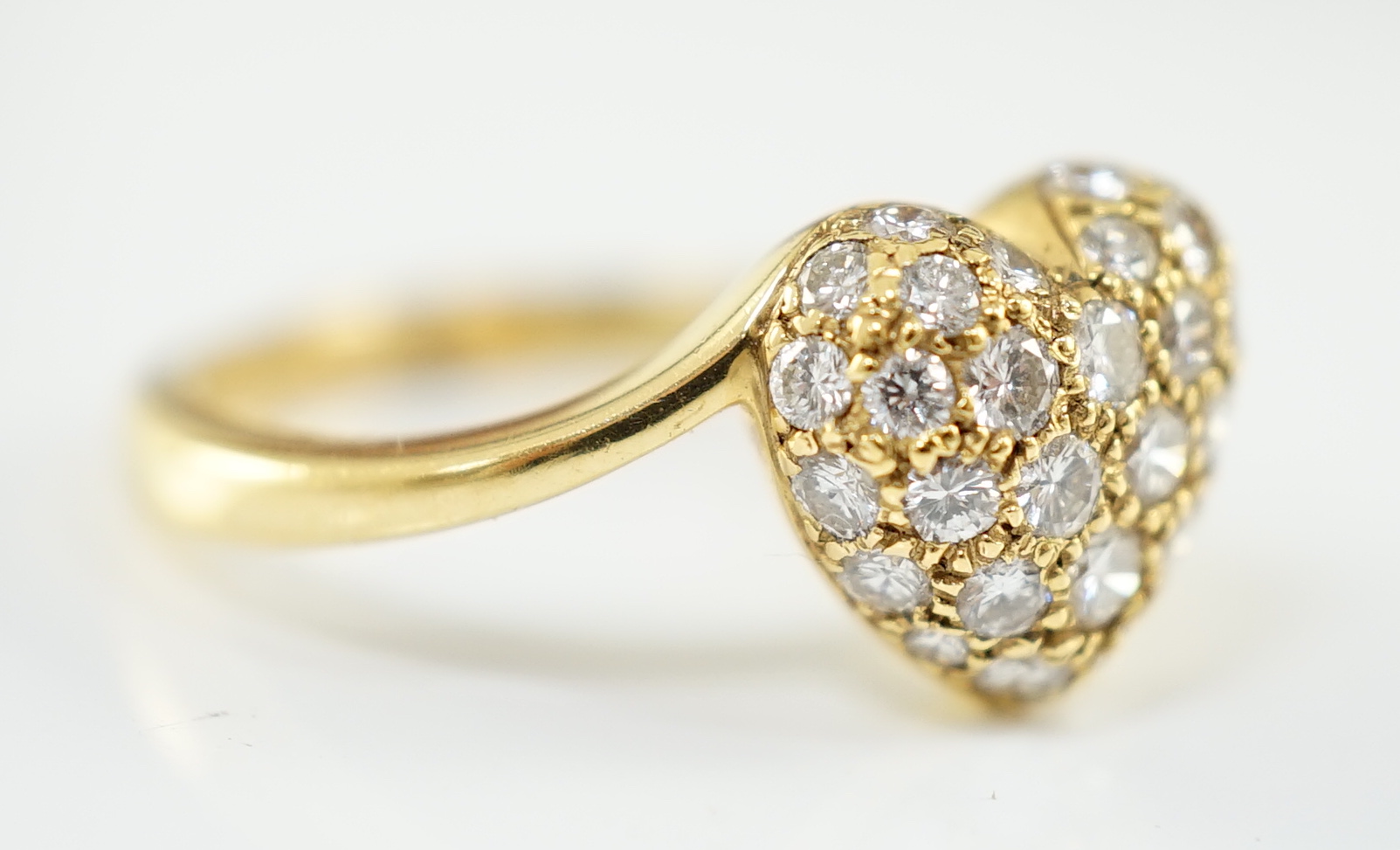 A modern Cartier 18ct gold and pave set diamond heart shaped ring